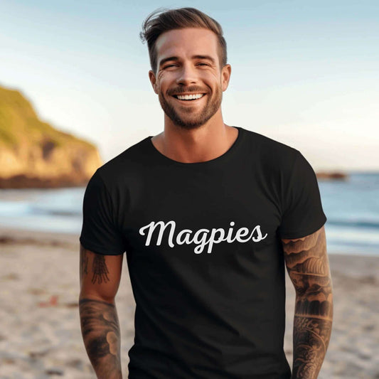 Collingwood Magpies black shirt on man with classic writng saying "Magpies" in team colours