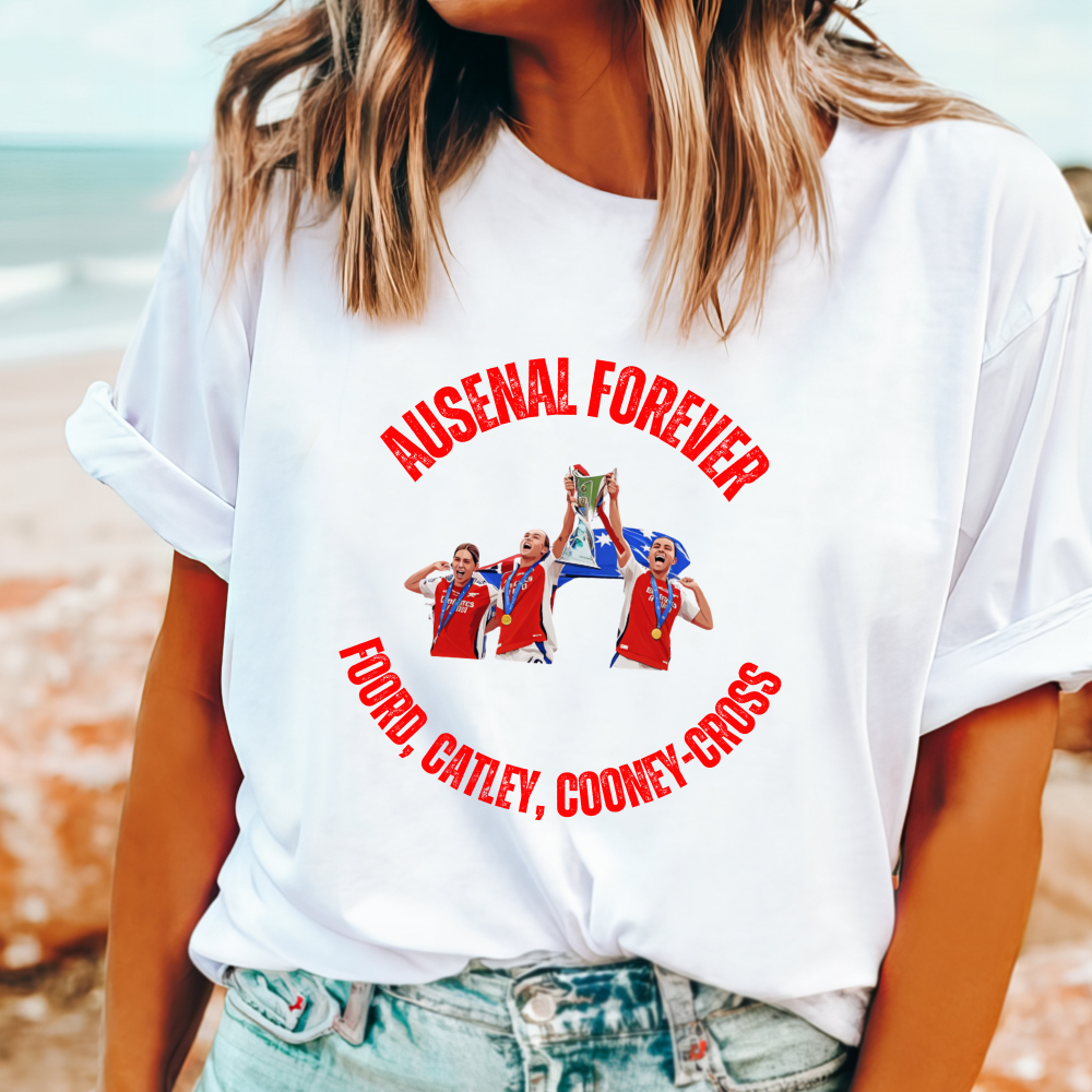 "Ausenal Forever" t-shirt with cartoon of Foord, Catley, and Cooney-Cross celebrating Champions League win