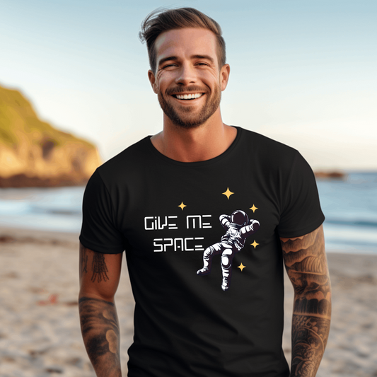 "Unisex t-shirt with 'Give me Space' text and graphic of a lone astronaut floating in space, perfect for introverts and space lovers."