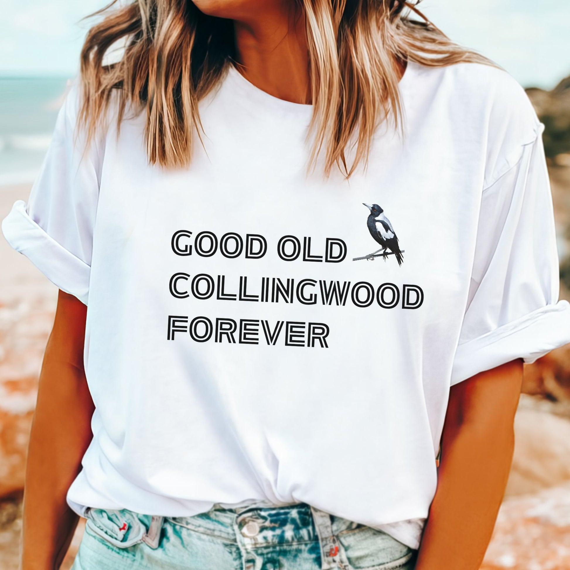 Woman wearing a white t-shirt with 'Good Old Collingwood Forever' with a magpie