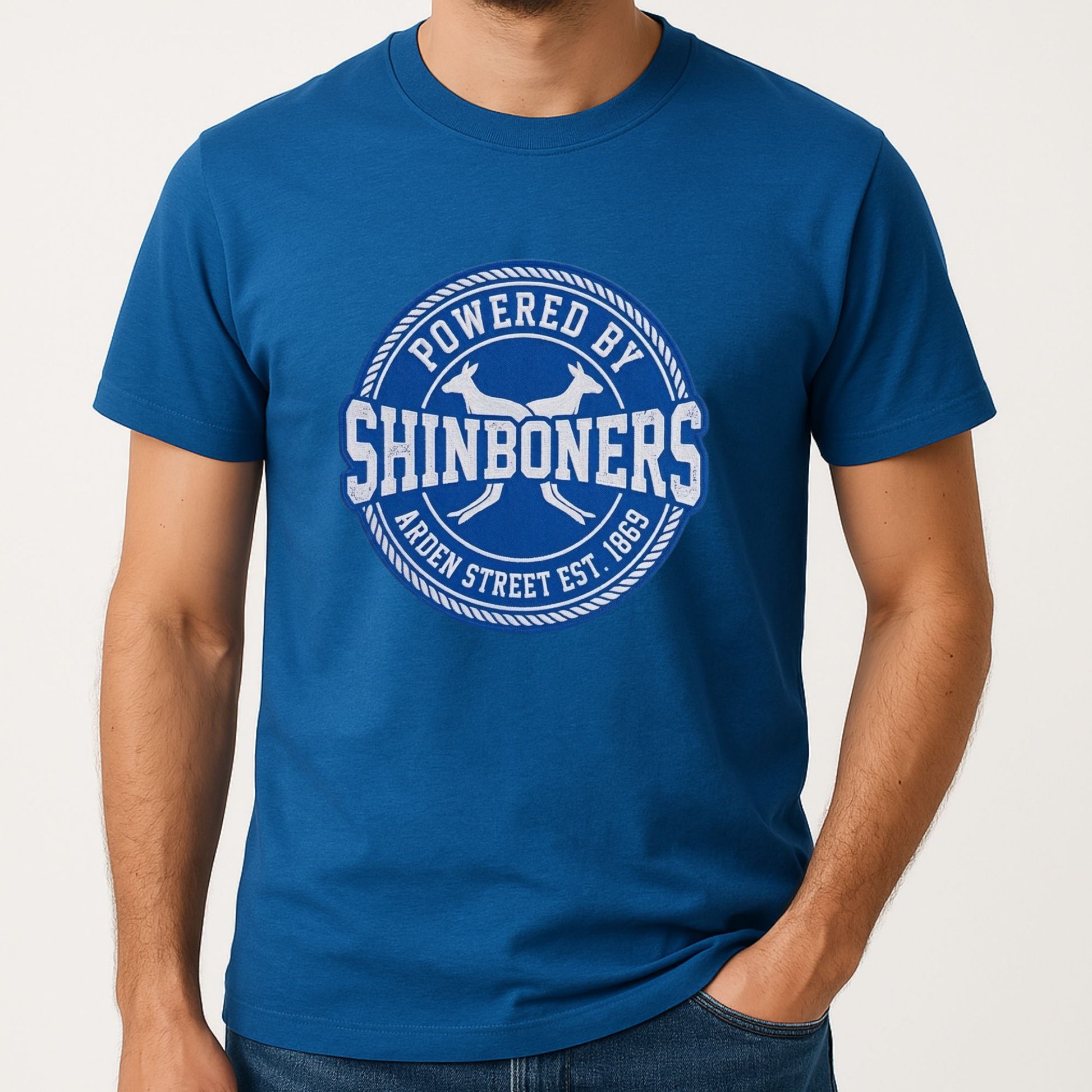 Person wearing a blue t-shirt with 'Powered by Shinboners' design on a plain background for North Melbourne fan