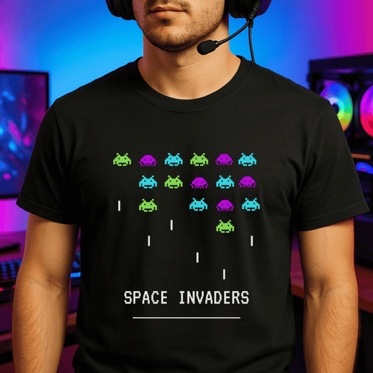 Person wearing a black t-shirt with 'Space Invaders' design in front of gaming equipment.