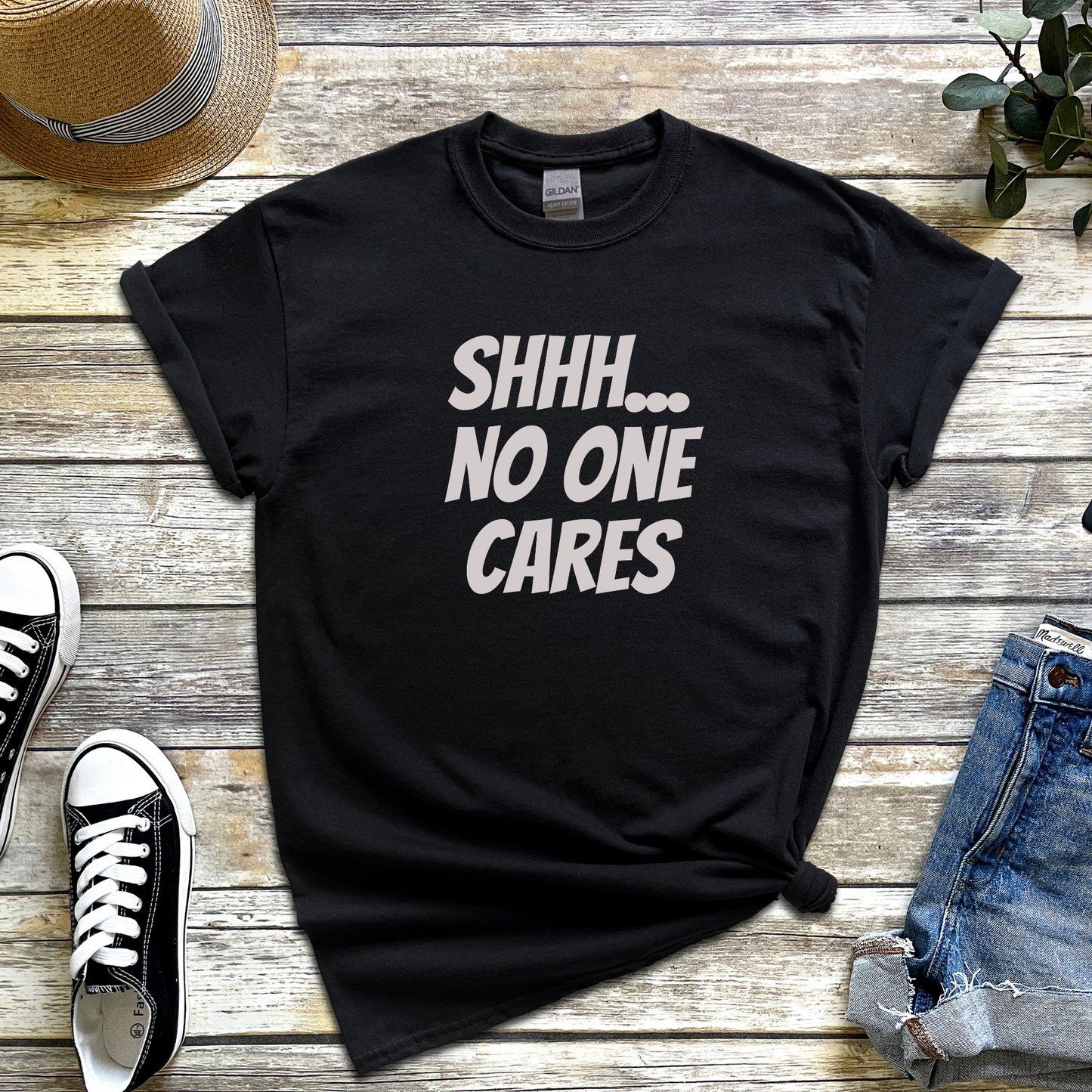 T-shirt with the phrase “Shhh No One Cares” — sarcastic and funny graphic tee for lovers of dry humour and bold statements.