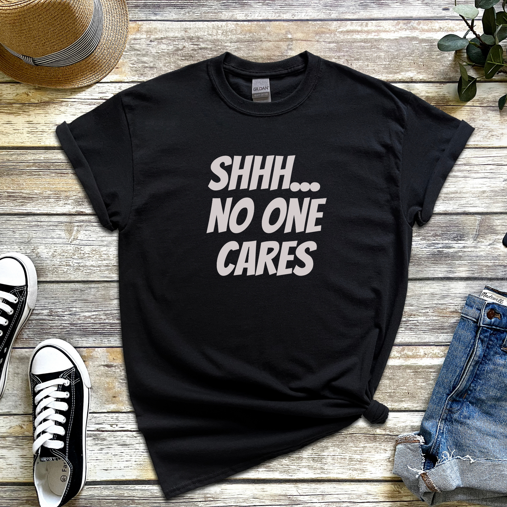 T-shirt with the phrase “Shhh No One Cares” — sarcastic and funny graphic tee for lovers of dry humour and bold statements.