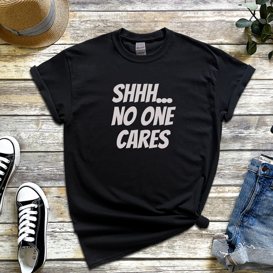 T-shirt with the phrase “Shhh No One Cares” — sarcastic and funny graphic tee for lovers of dry humour and bold statements.